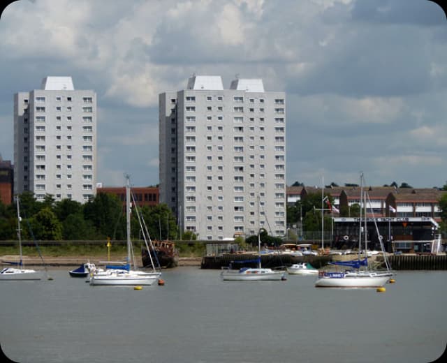 Waterfront view near Grays with residential towers and sailboats